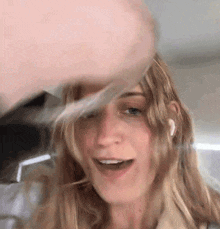 a close up of a woman 's face with a man 's hand holding her hair .