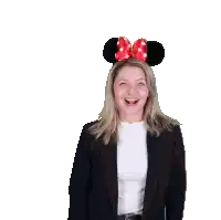 a woman wearing a headband with minnie mouse ears and a bow