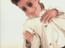 a blurry picture of a man wearing sunglasses and a white shirt