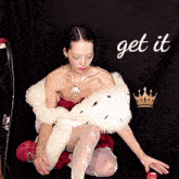 a woman in a fur coat is kneeling down with the words get it written in white