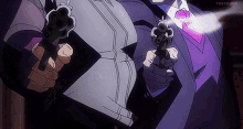 a man in a suit and tie is holding two guns in his hands .