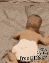 a baby in a diaper is crawling on a bed with freecdn written on the bottom