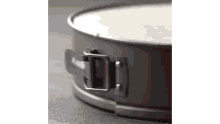 a close up of a cake pan with a latch on it .