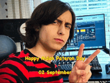 a young man giving a peace sign in front of a computer screen with the date september 2