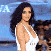 a woman with curly hair wearing a white swimsuit