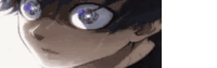 a close up of a person 's face with big blue eyes and glasses .