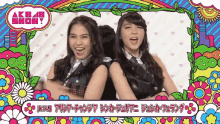 two girls are standing next to each other in front of a colorful background that says akb48 show