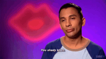 a man is making a face and saying `` you shady bitch '' in front of a pink lip .