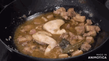 a pan of food is being cooked with the words made in animotica on the bottom