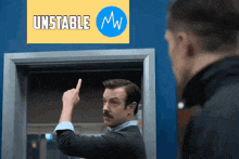 a man with a mustache is pointing his finger at another man in front of a sign that says `` unstable mw '' .
