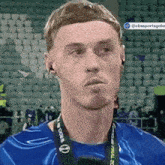 a man wearing headphones and a lanyard that says world cup