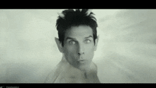 a man with horns on his head is making a funny face in a black and white photo
