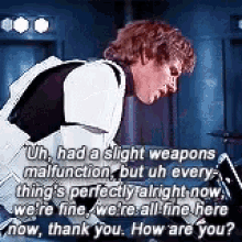 a man in a storm trooper costume is talking to another man in a room .