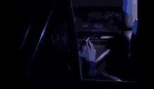 a man is smoking a cigarette while driving a car at night .