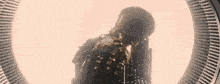 a silhouette of a person standing in front of a circle