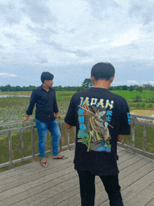 a man wearing a black shirt that says japan on the back
