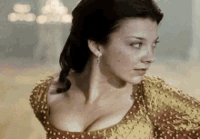 a woman in a yellow and red dress with a very large breast is looking to the side .