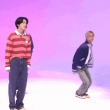 two men are standing next to each other in front of a purple background