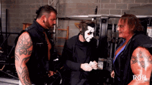 three men are standing next to each other with the word roh on their chest