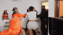 a group of women are fighting in a room with the word zeus on the bottom