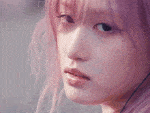 a close up of a girl with pink hair