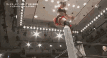 a female wrestler is jumping off a rope in a wrestling ring