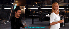 a man and a woman standing next to each other with the woman saying his first name is agent