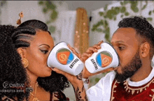 a man and woman drinking from cups with eritrea on them