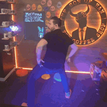 a man is dancing in front of a sign that says son of fancy shop