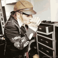 a man wearing a hat and a jacket that says ' johnny depp ' on the sleeve