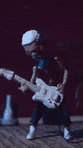 a statue of a man playing a white guitar