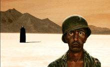 a man in a military helmet stands in a desert
