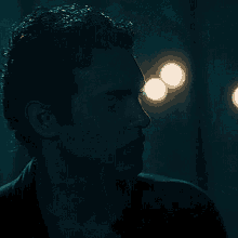 a close up of a man 's face in the dark