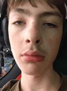 a close up of a person 's face with headphones on .