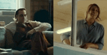 a man is sitting on a couch and a woman is standing next to a window .