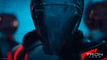 a close up of a man wearing a helmet that says tron ares on it