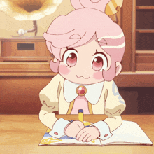 a girl with pink hair is sitting at a desk with a book