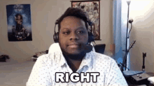 a man wearing headphones and a white shirt is sitting in front of a computer screen with the word right written on his face .