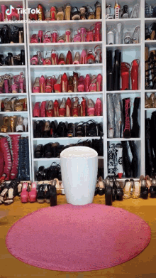 a closet filled with lots of high heels including a white stool