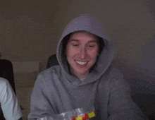 a person in a hoodie holds a bag of mcdonald 's hot dogs