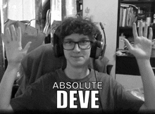 a black and white photo of a boy wearing headphones and a shirt that says " absolute deve "