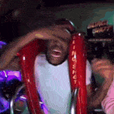 a man is laughing while riding a slingshot ride at an amusement park