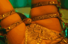 a snake is sitting on a woman 's leg in a snake print outfit