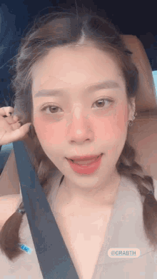 a close up of a woman 's face while sitting in a car