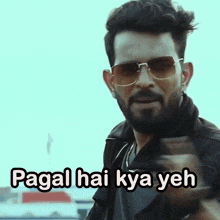 a man wearing sunglasses and a black jacket says " pagal hai kya yeh " while pointing at the camera