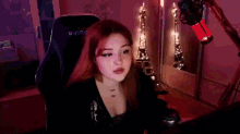a woman is sitting in a chair with her mouth open .