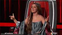 a woman is sitting in a chair with her arms outstretched .