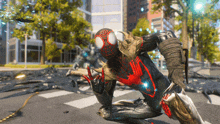 a man in a spider man costume is kneeling on the street