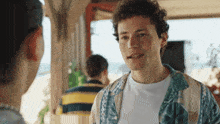 a man with curly hair is talking to a woman