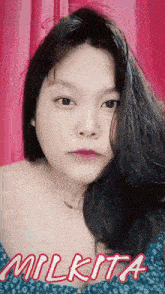 a close up of a woman 's face with the name milkita written below her